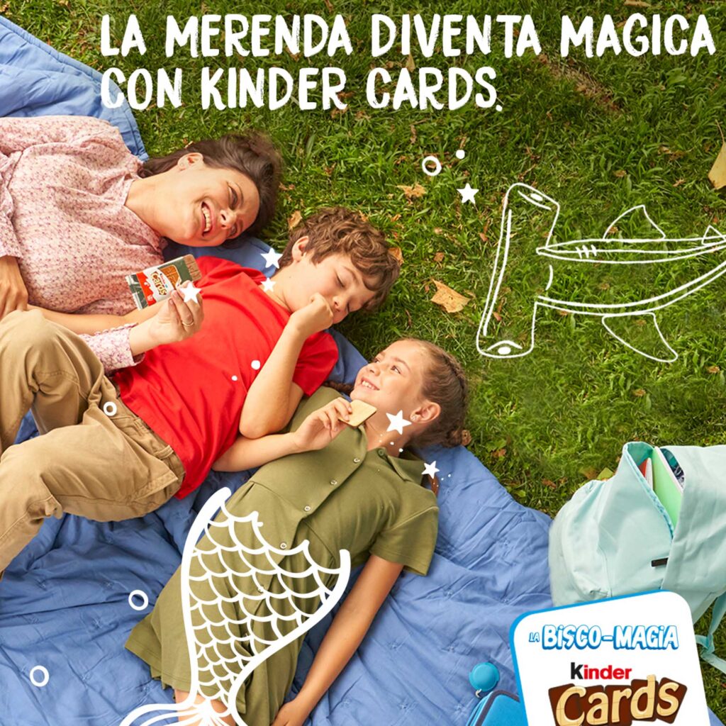 A relaxed picnic moment featuring a family lying on a blanket, enjoying Kinder Cards with whimsical doodles.