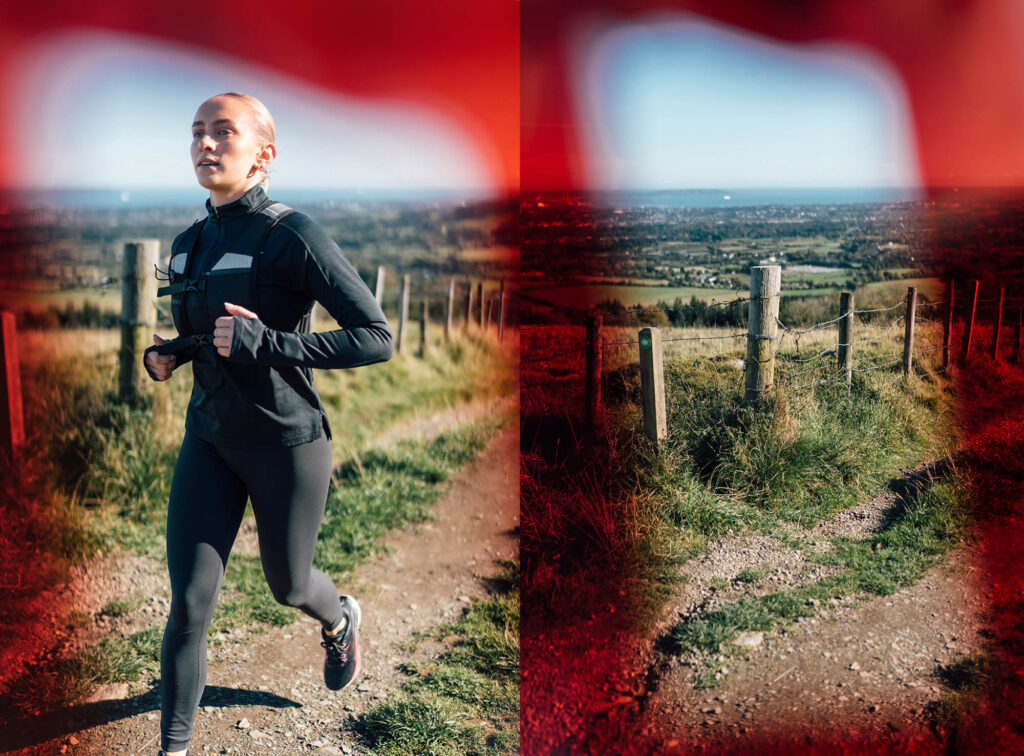 A trail runner is captured mid-jog in a grassy field under a clear blue sky. The serene backdrop highlights motion, freedom, and connection to nature. Red gel framed